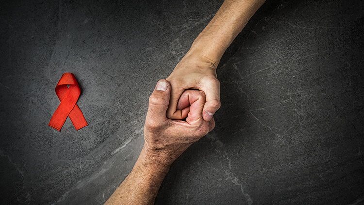 Hands with HIV awareness ribbon