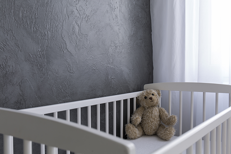 A teddy bear in a crib