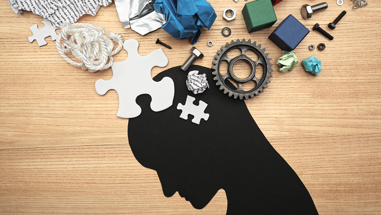silhouette man with gears and puzzle pieces above his head