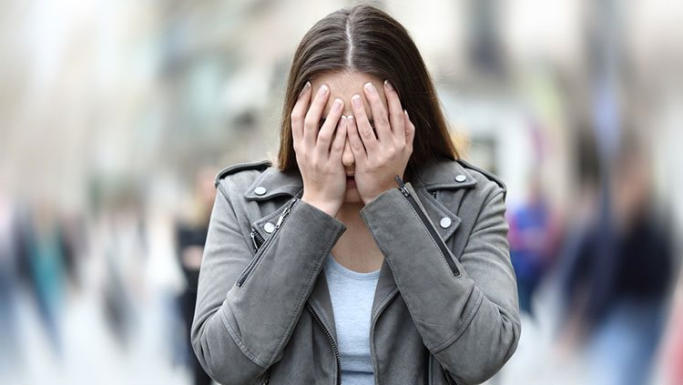 Woman with hands on her face