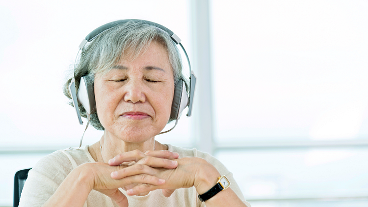 Image of elderly lady listening to headphones