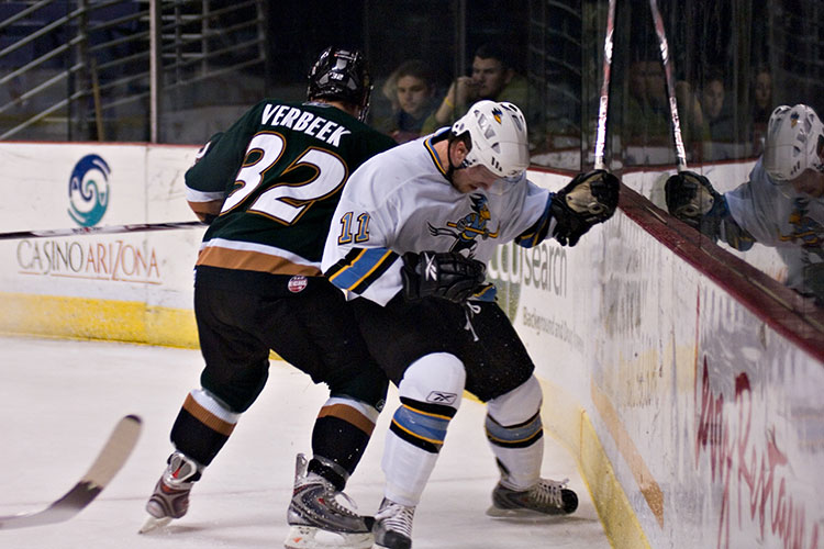 Hockey players body checking