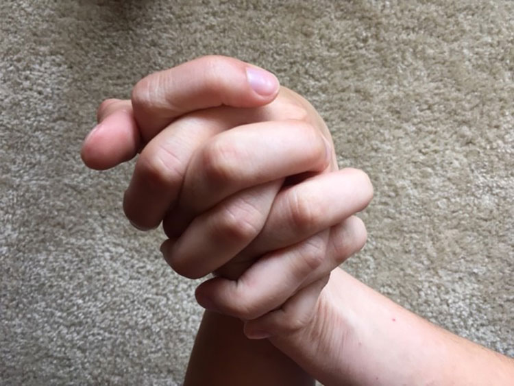 Hands laced together