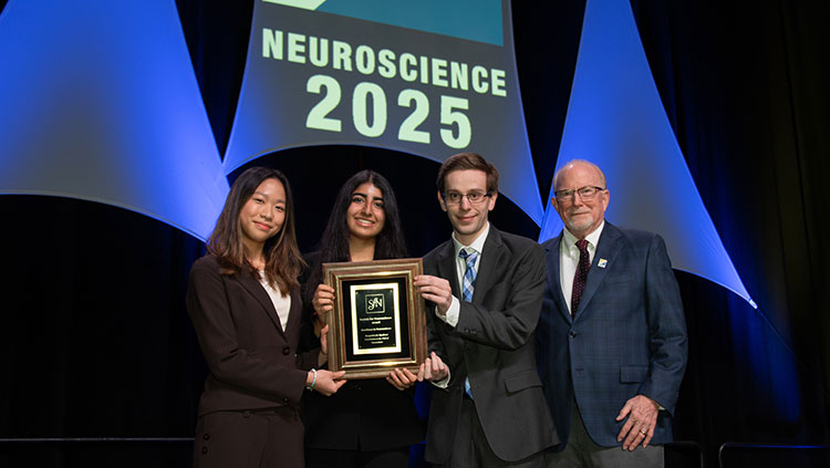 Four people accepting an award