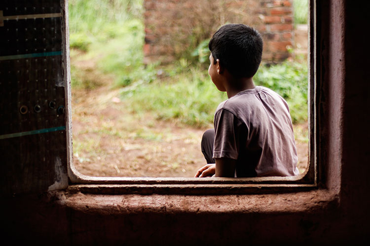 Little boy sitting outside
