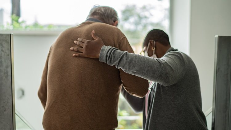 Man helping elder