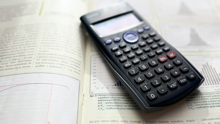 Photo of a scientific calculator on an open math textbook