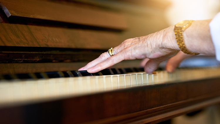 Shot of a senior woman playing the piano at home
